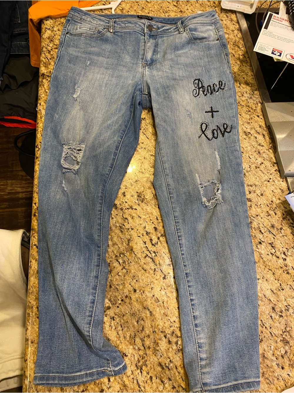 Bebe Light Wash Distressed Jeans with 'Peace + Love' Embroidery